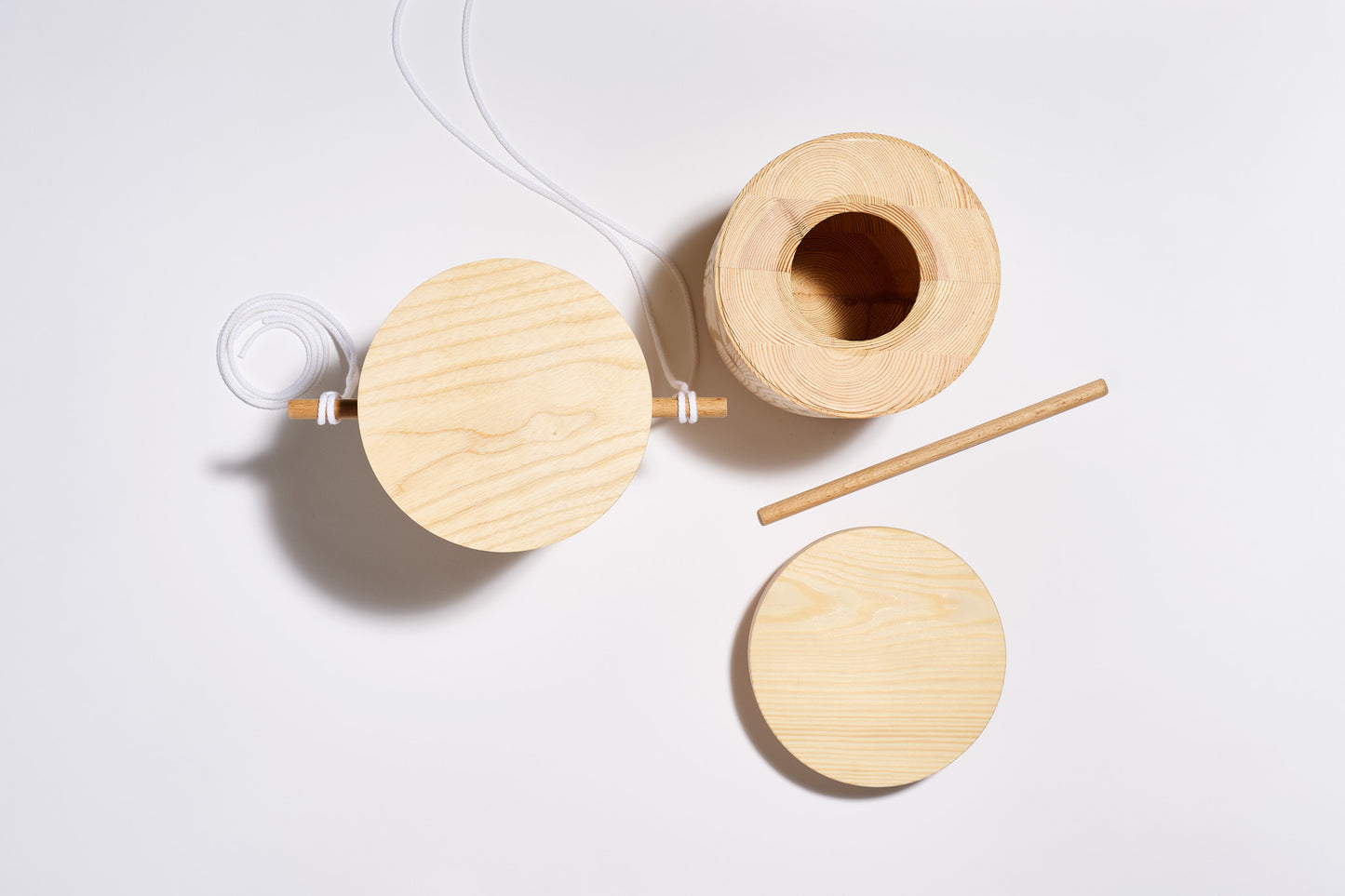 Top view of two wooden urns one closed, one open on a white surface