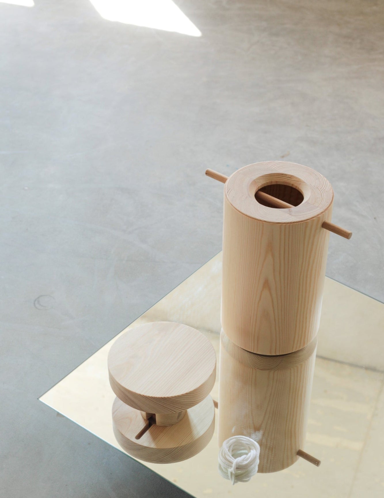 Wooden urn parts photographed on a mirror 