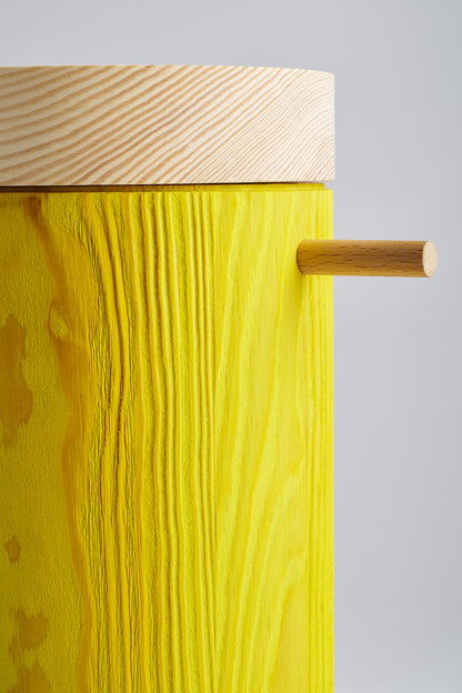 Close up of bright yellow colored wooden urn