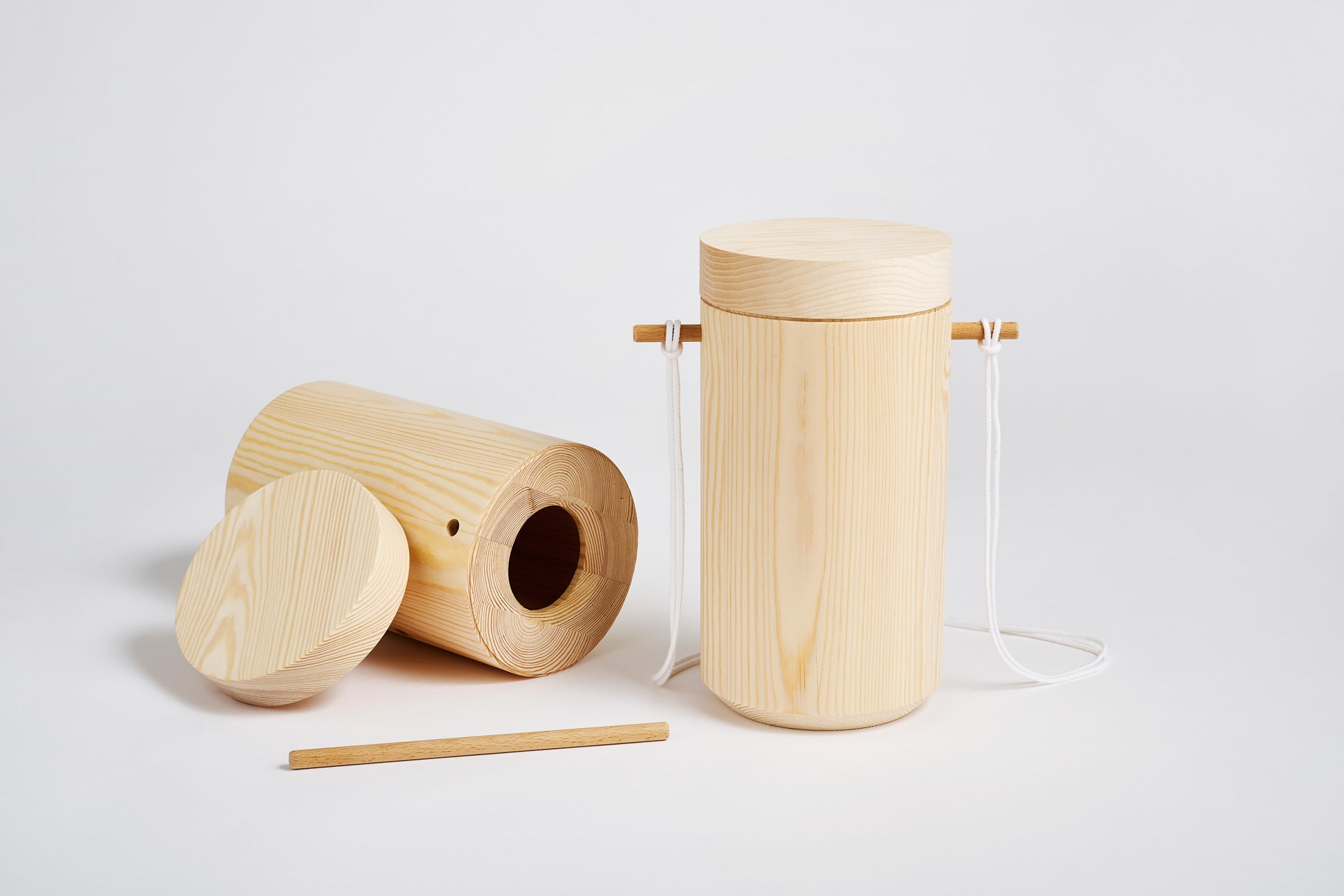 Two wooden urns one closed, one open on a white background